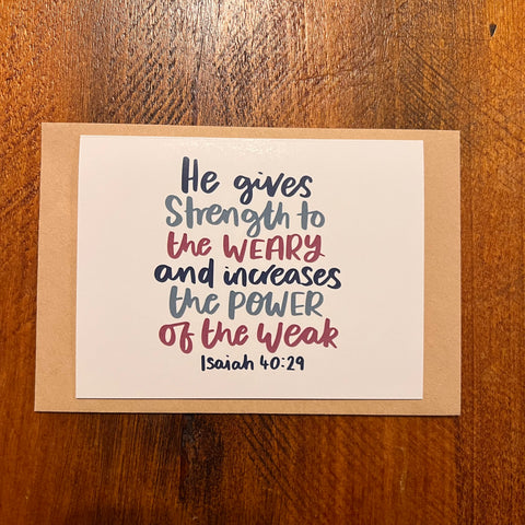 Card with motivational quote on a wooden surface