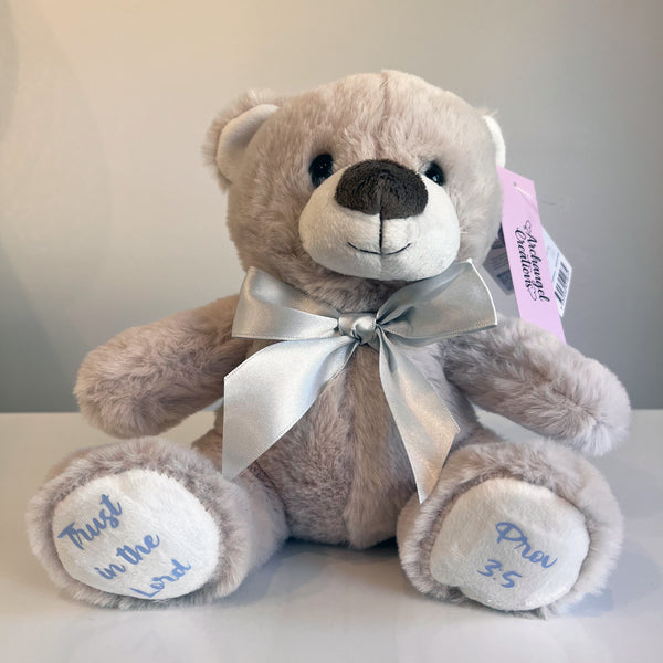 Plush teddy bear with a silver bow with embroidered bible verse