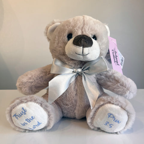 Plush teddy bear with a silver bow with embroidered bible verse