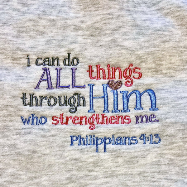 Embroidered quote on fabric with 'I can do all things through Him who strengthens me' from Philippians 4:13.